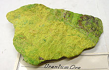 Block of yellow-green stone with rough surface.